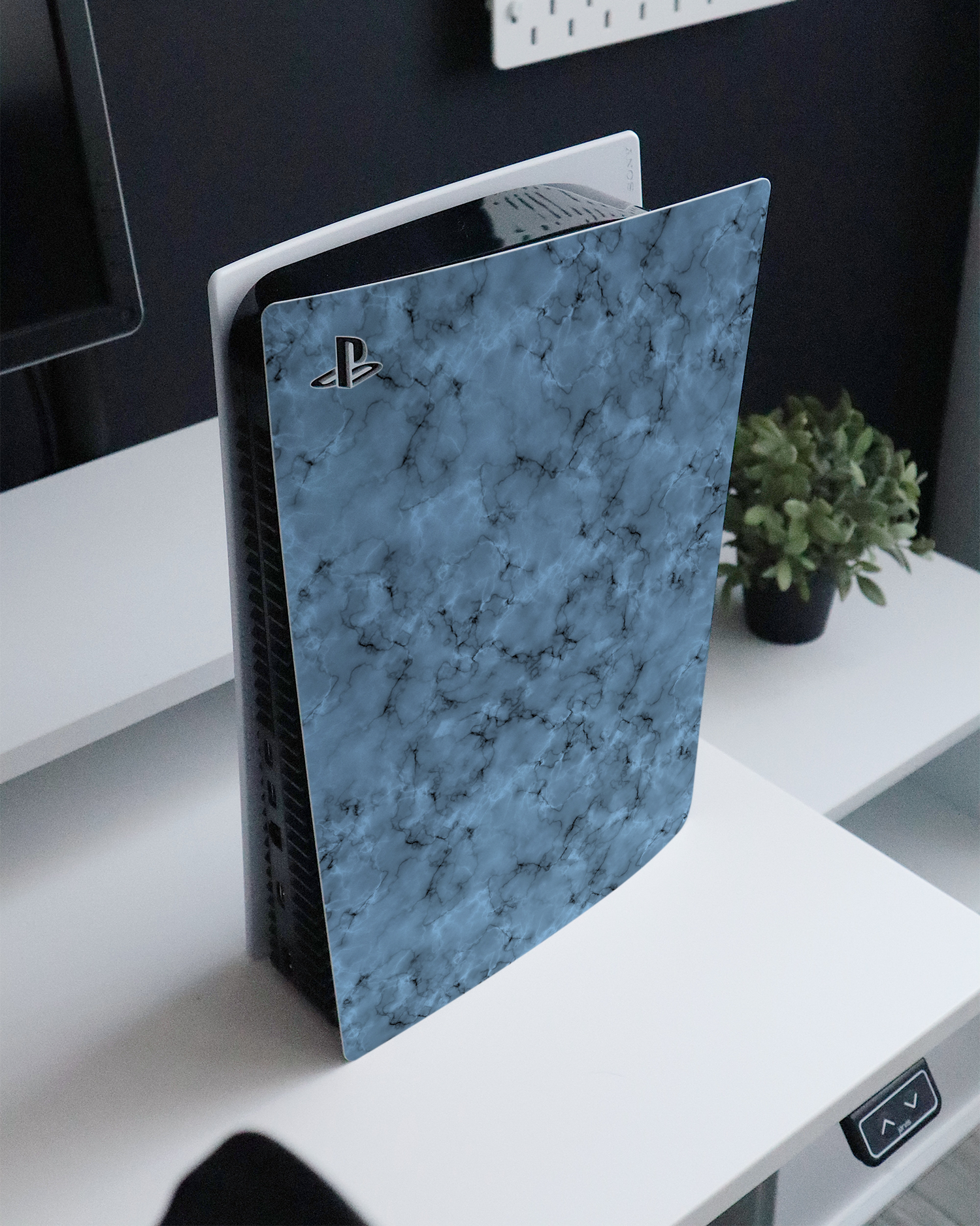 Blue Marble Console Skin for Sony PlayStation 5 Digital Edition standing on a sideboard 