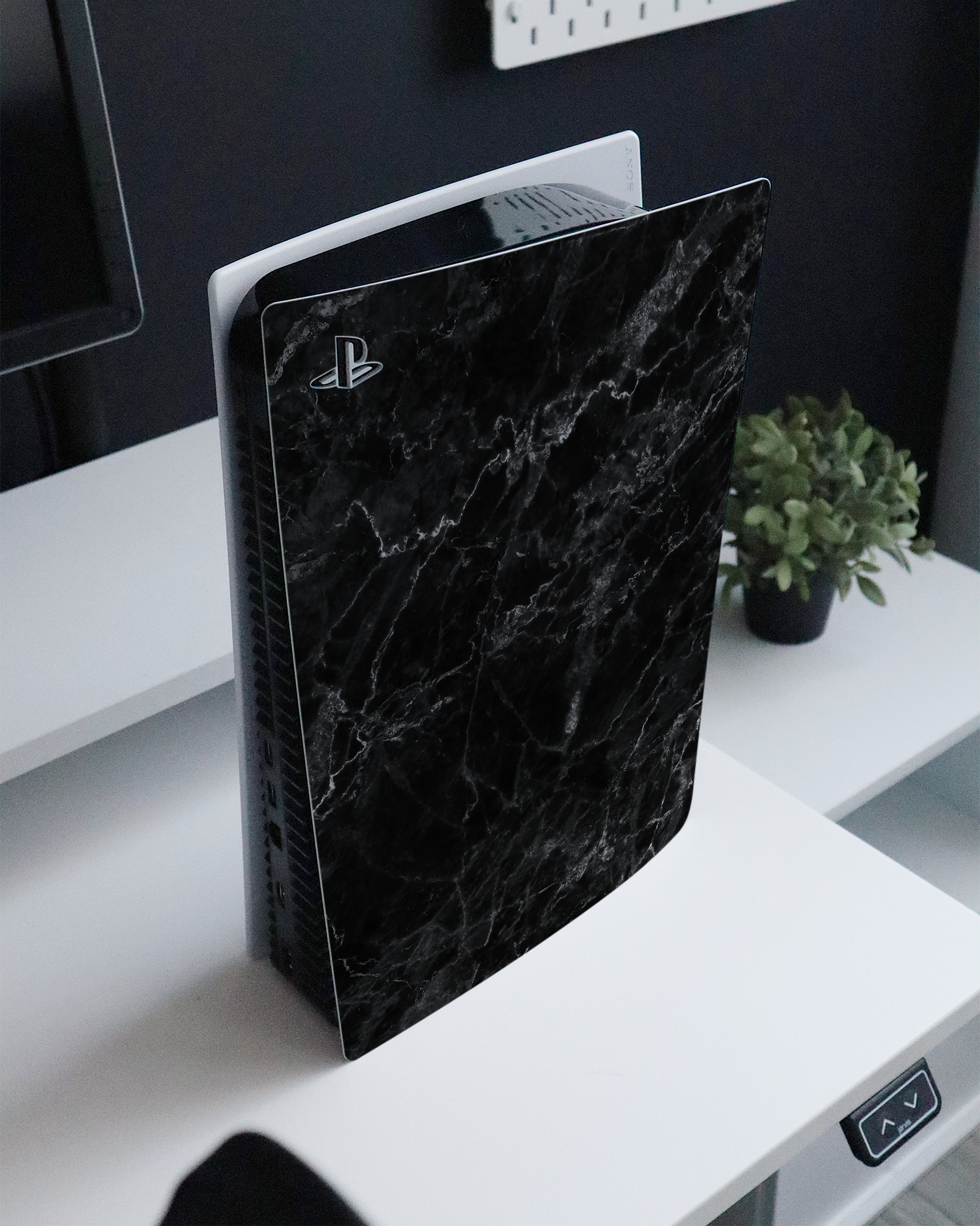 Midnight Marble Console Skin for Sony PlayStation 5 standing on a sideboard 