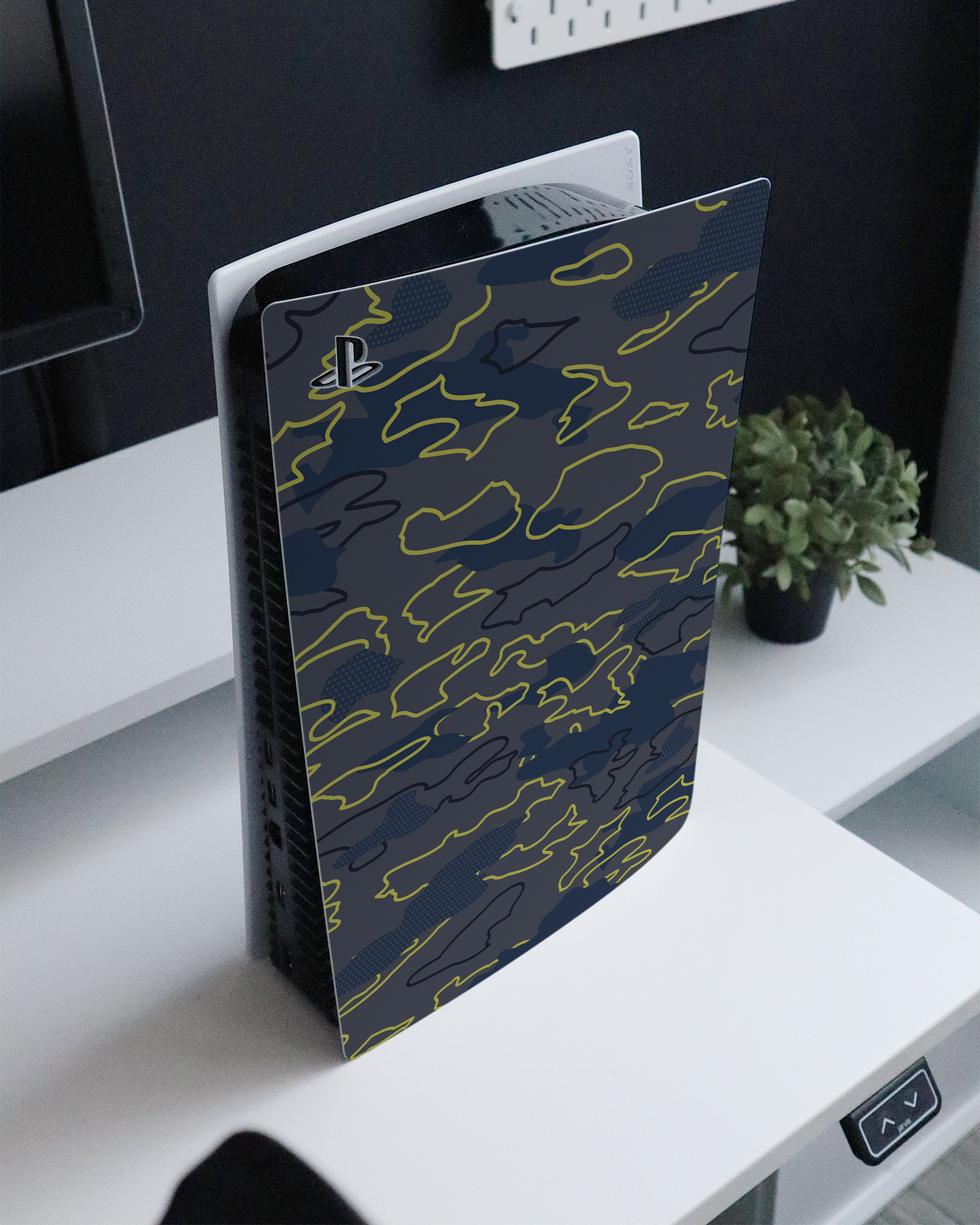 Linear Camo Console Skin for Sony PlayStation 5 standing on a sideboard 