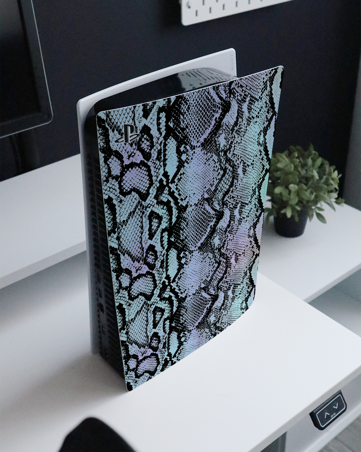 Groovy Snakeskin Console Skin for Sony PlayStation 5 standing on a sideboard 