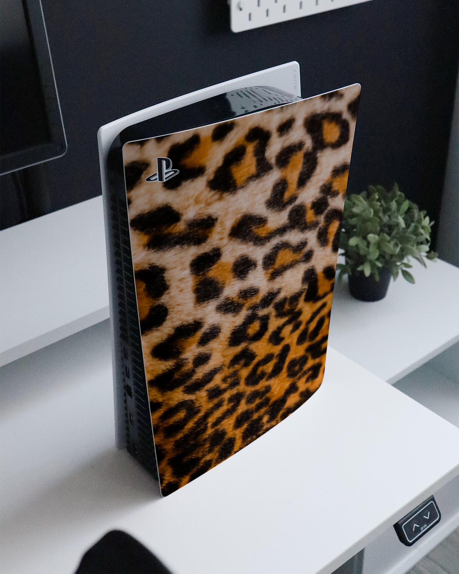 Leopard Pattern Console Skin for Sony PlayStation 5 standing on a sideboard 