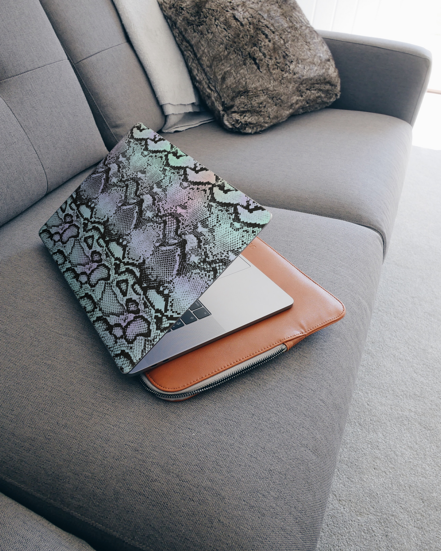 Groovy Snakeskin Laptop Skin for 15 inch Apple MacBooks on a couch