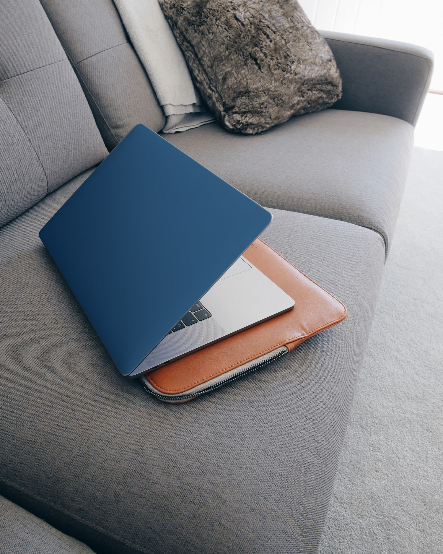 CLASSIC BLUE Laptop Skin for 15 inch Apple MacBooks on a couch