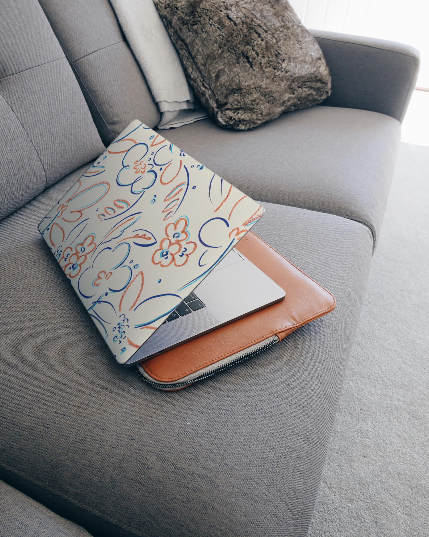Bloom Doodles Laptop Skin for 15 inch Apple MacBooks on a couch