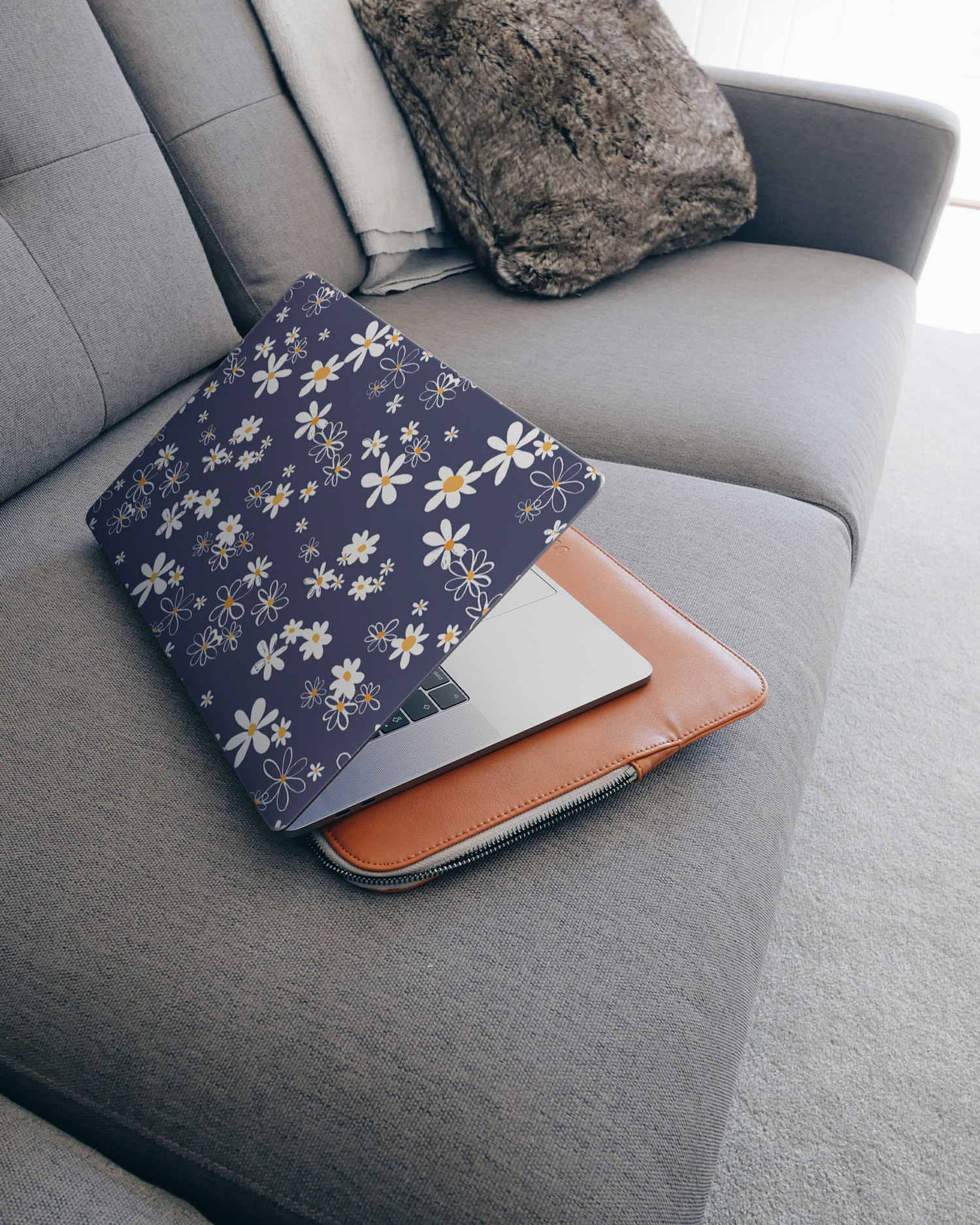 Navy Daisies Laptop Skin for 15 inch Apple MacBooks on a couch