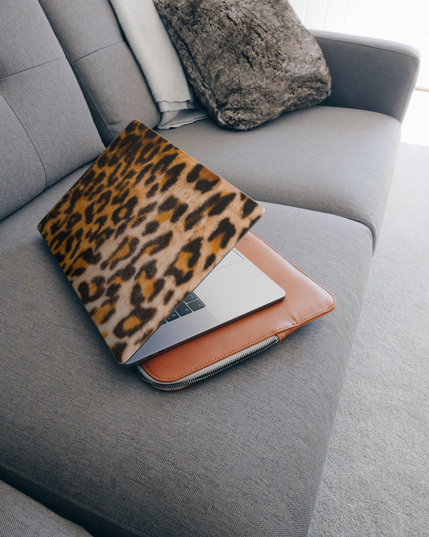 Leopard Pattern Laptop Skin for 15 inch Apple MacBooks on a couch
