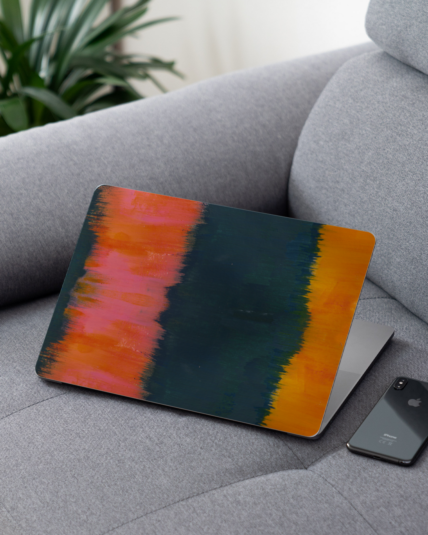 Ombre Gradient Laptop Skin for 13 inch Apple MacBooks on a couch
