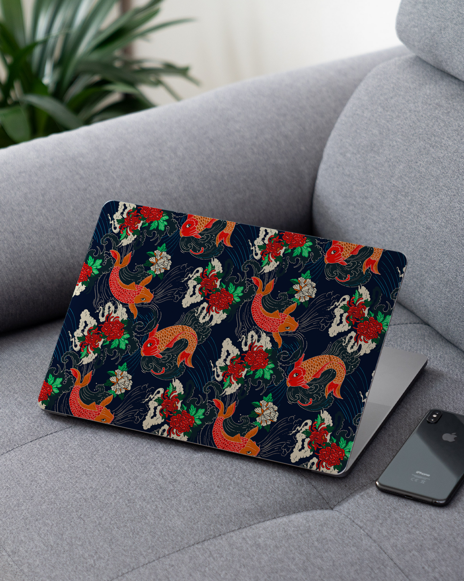 Repeating Koi Laptop Skin for 13 inch Apple MacBooks on a couch
